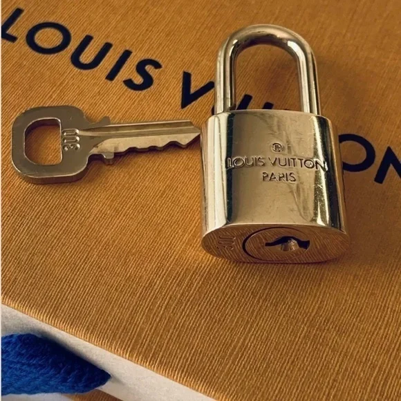 NEAR MINT Louis Vuitton lock and key set.